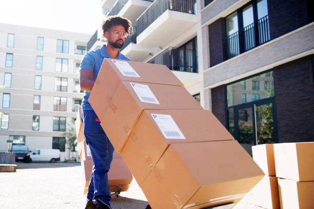 Movers relocating office furniture and equipment