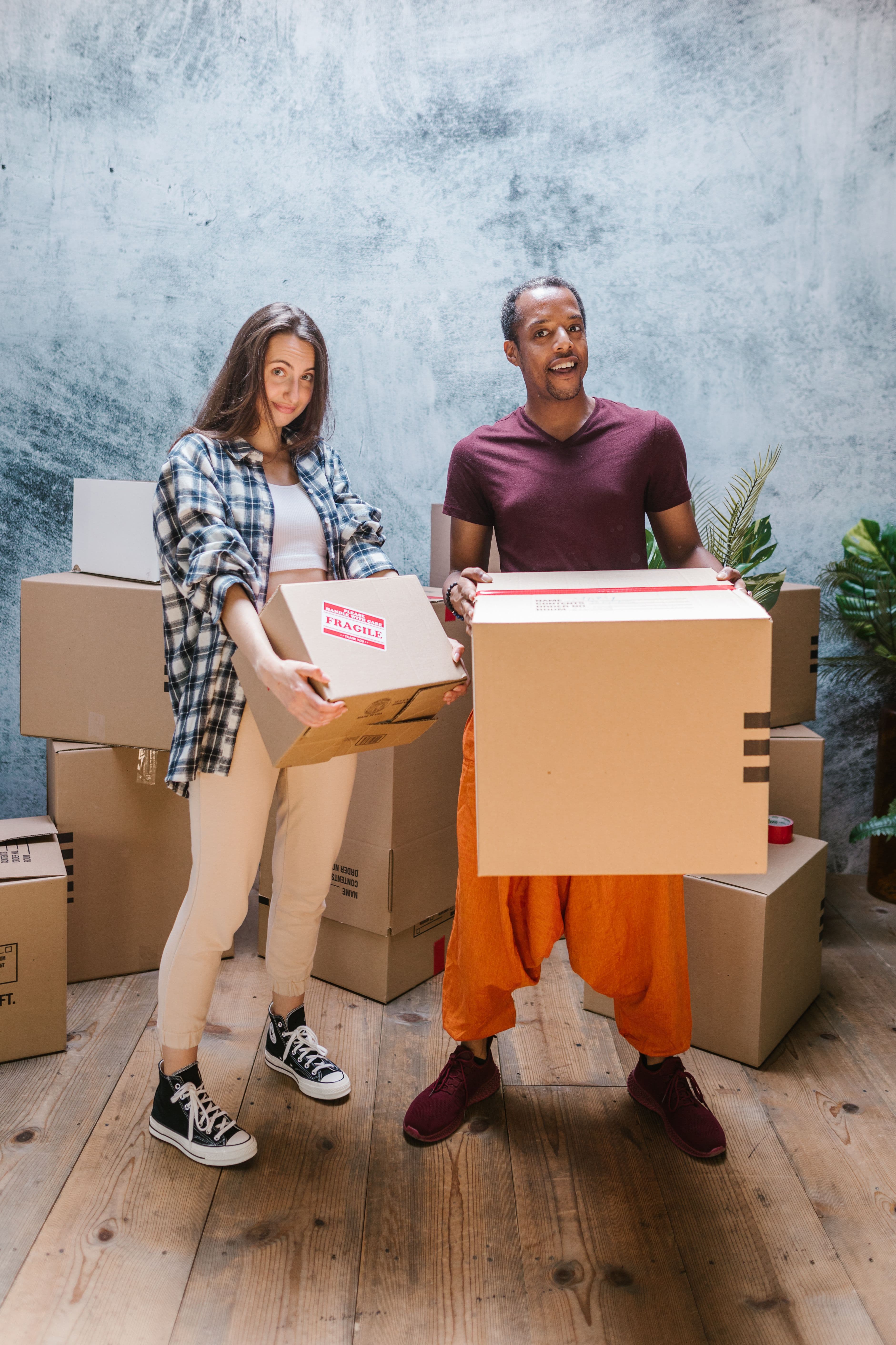 Smiling professional mover in uniform standing ready to help