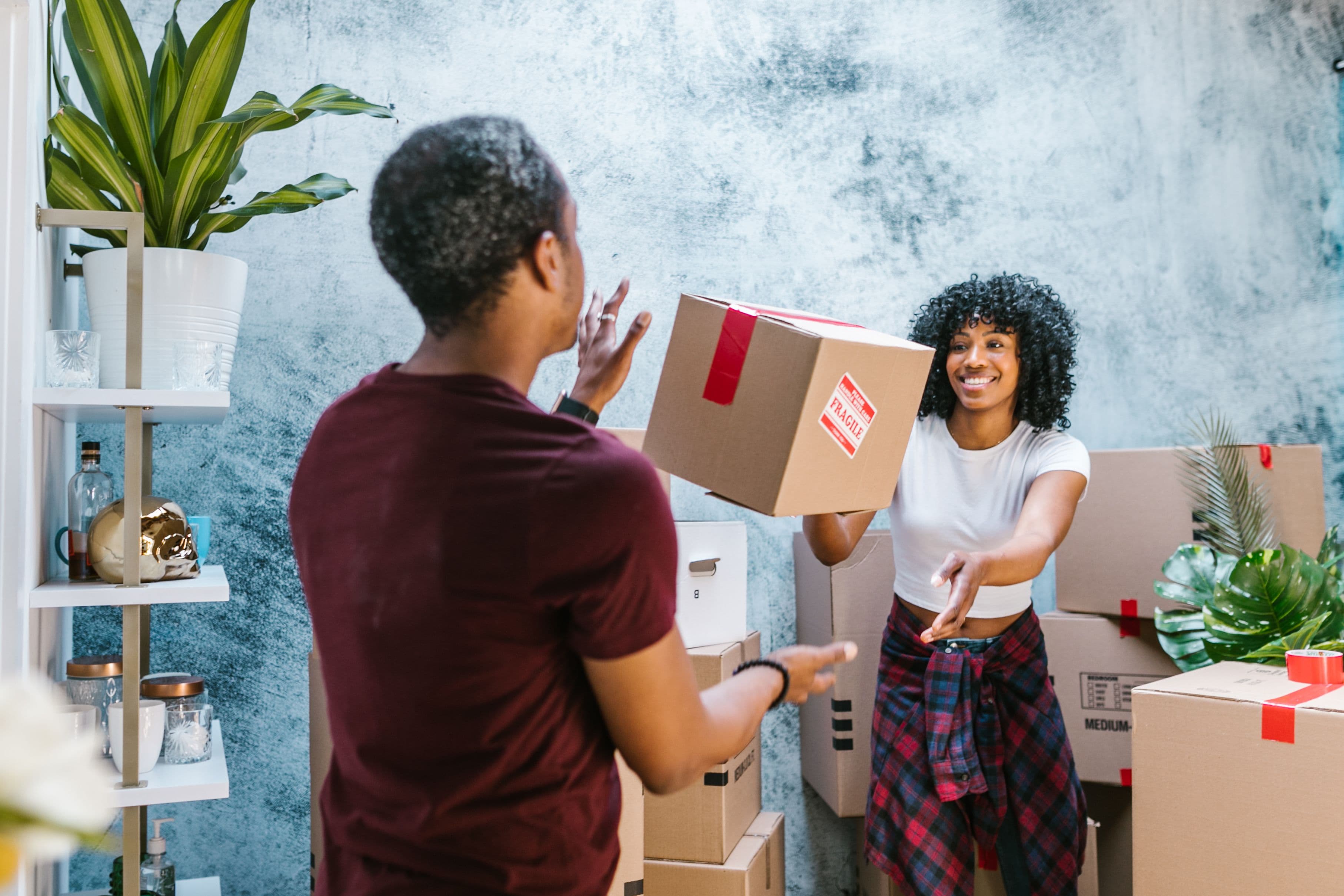 Movers carefully wrapping and packing household items